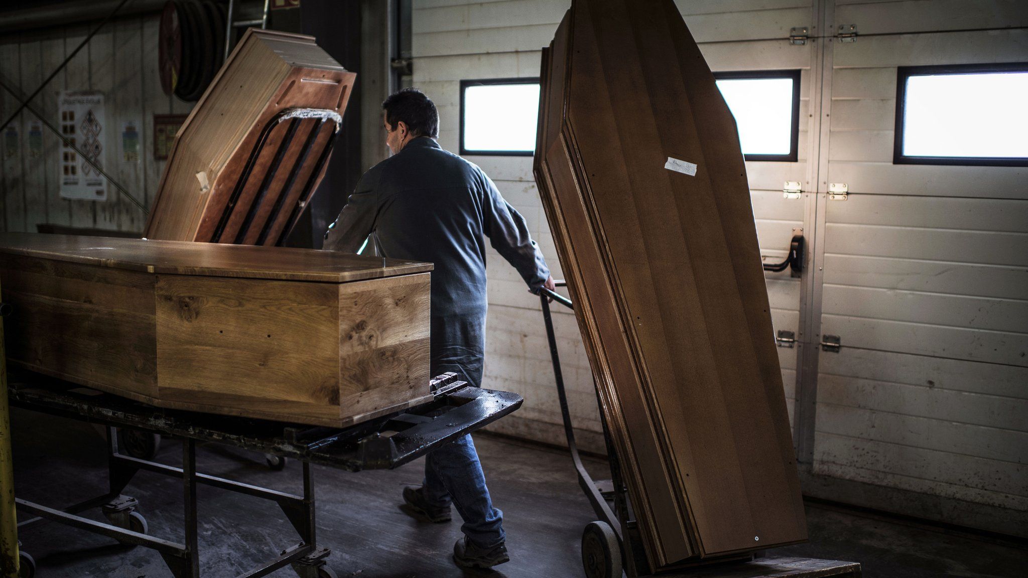 A coffin-maker with three coffins