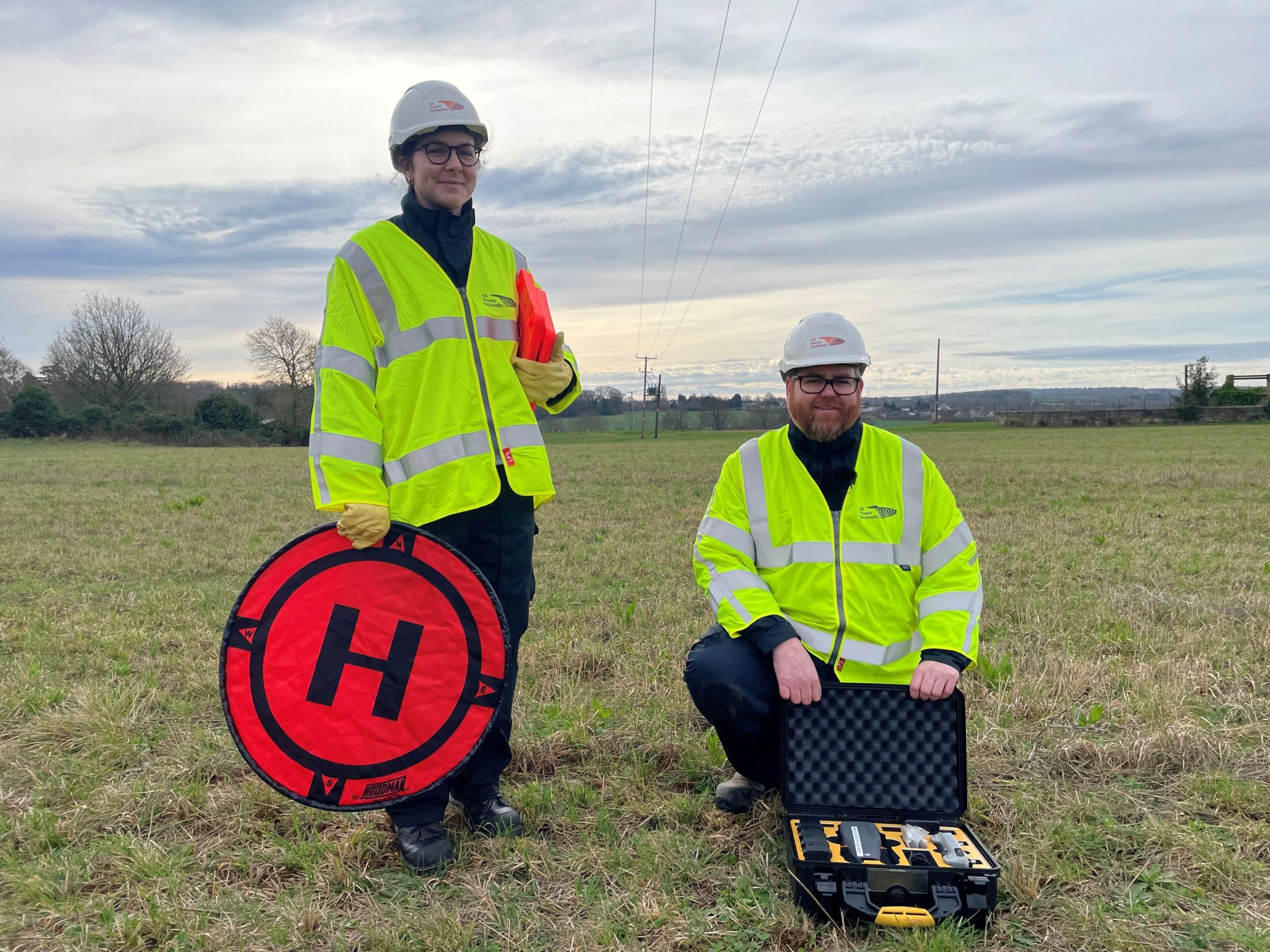 Two engineers wearing hi-vis with the drone kit 