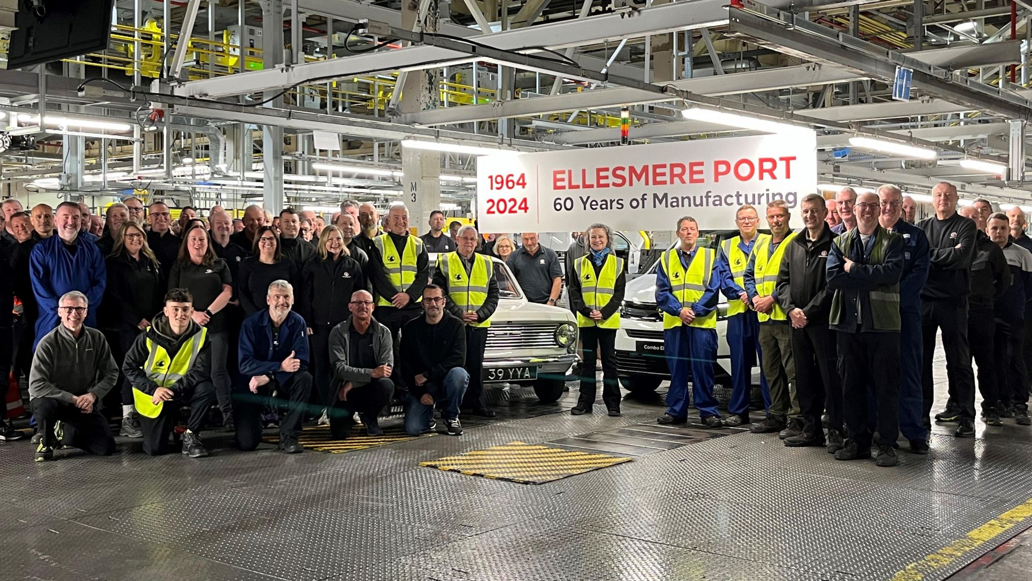 A crowd of Vauxhall staff posing for a picture at the Ellesmere Port factory to celebrate 60 years 