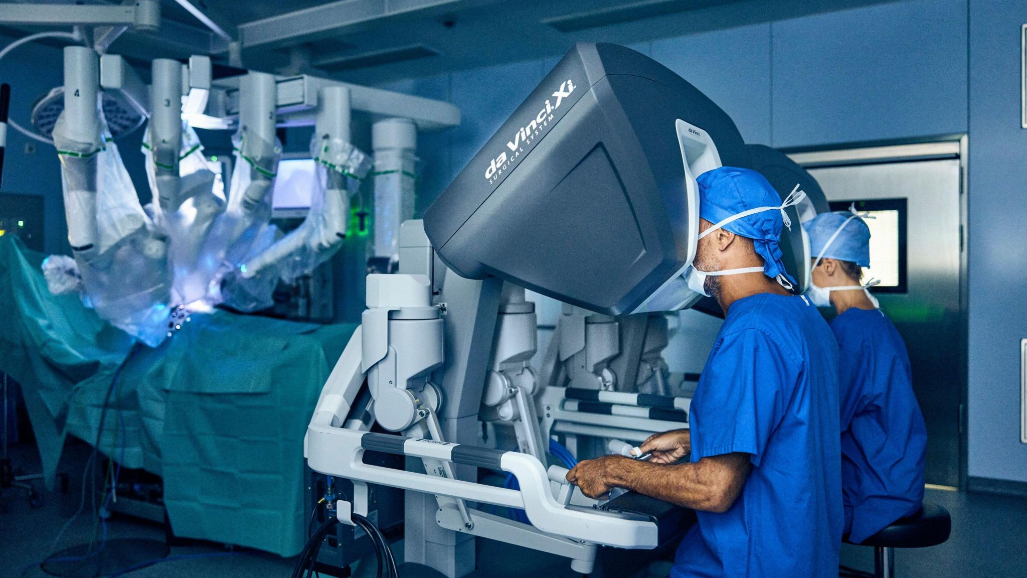 Two surgeons operating a robotic system