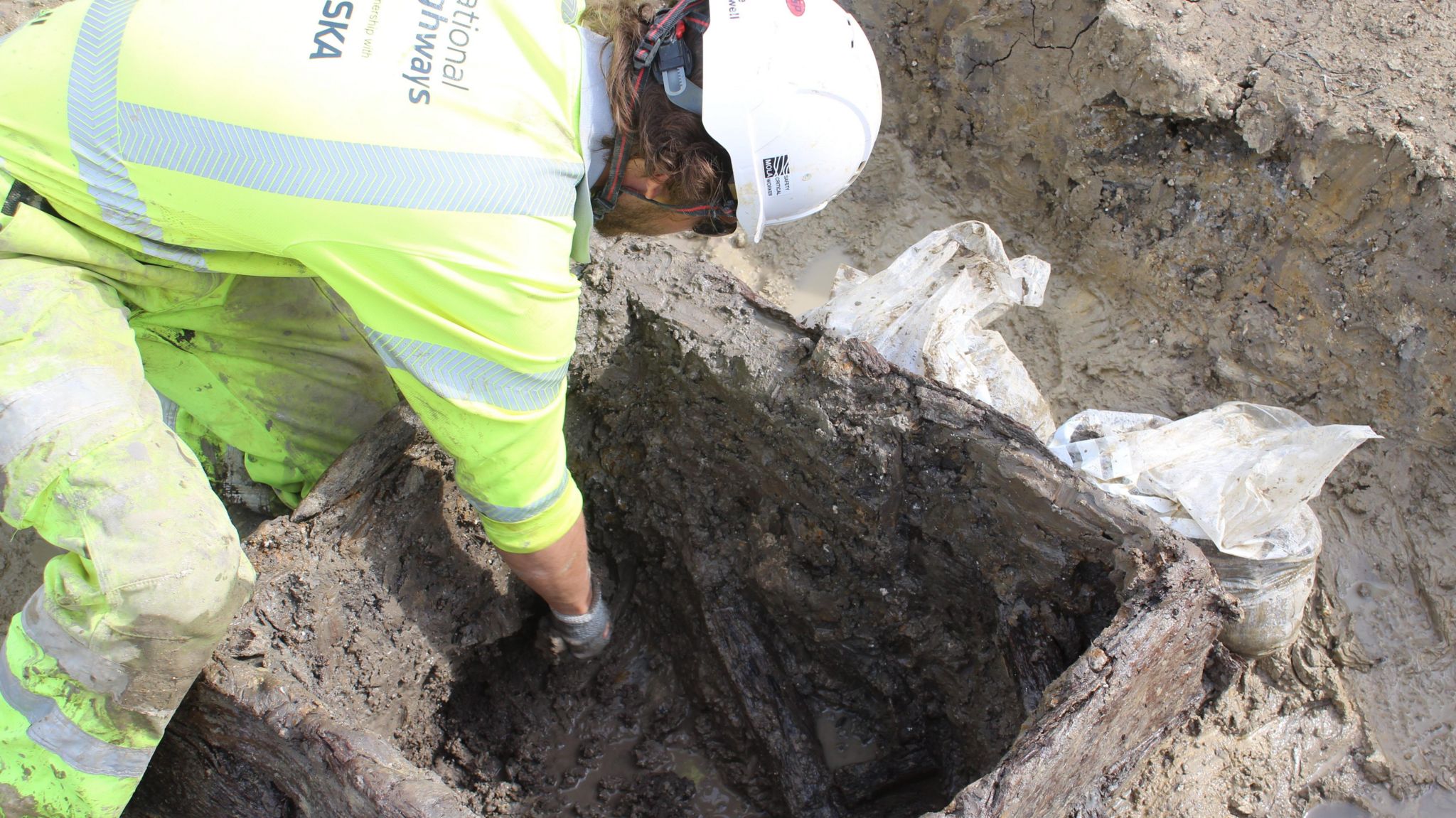 Archaeologist examining a Roman well