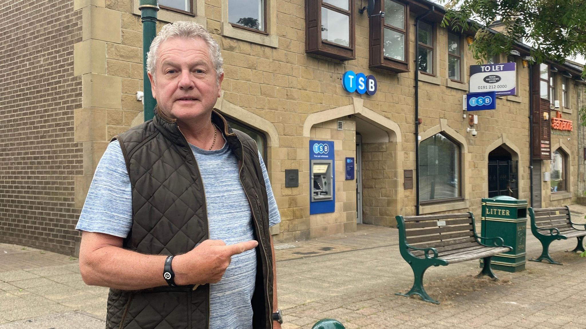 Pensioner Billy FIddes pointing to the branch of TSB in Bedlington