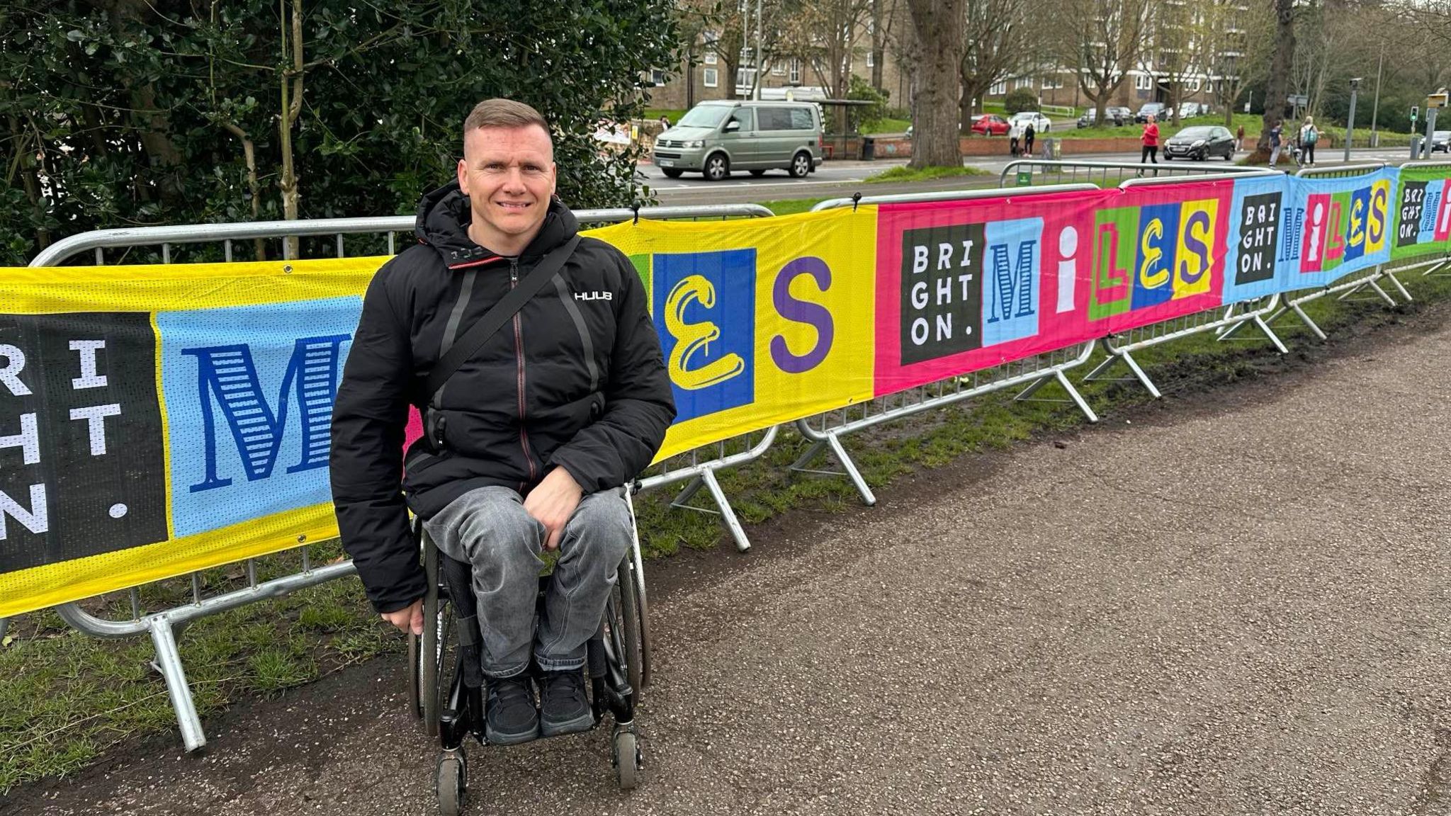 Paralympic gold medallist David Weir in front of signs for the Brighton Miles event