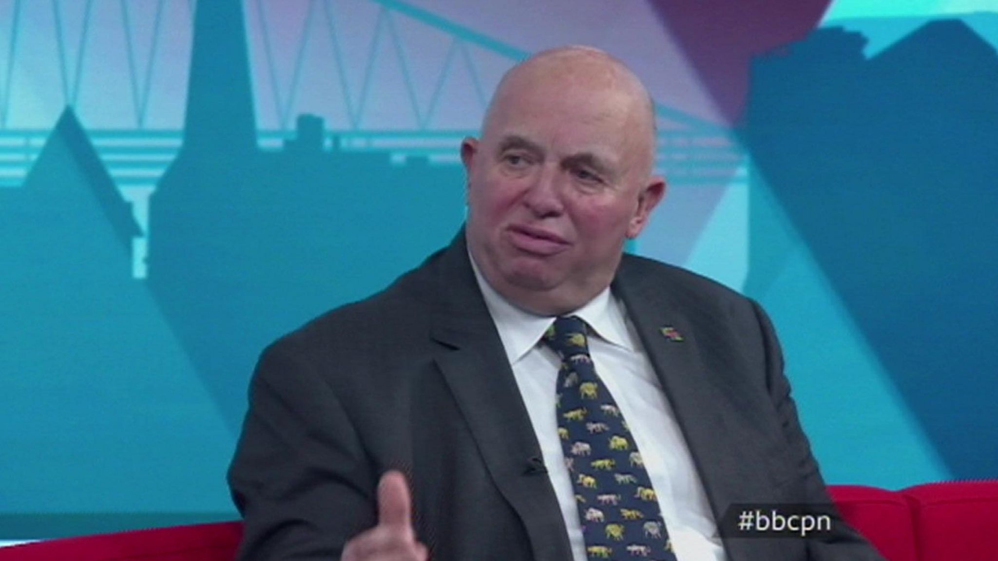 Conservative county councillor Colin Davie, wearing a dark suit and tie containing small pictures of animals 