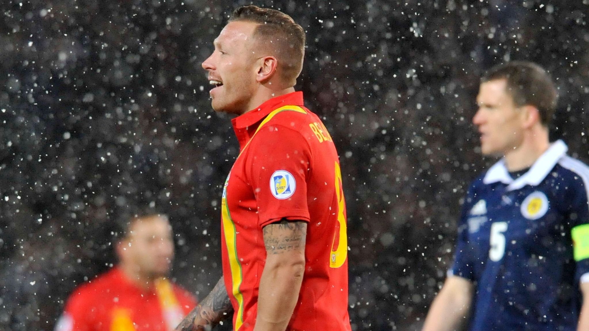 Craig Bellamy smiles as snow falls in Wales' game against Scotland at Hampden Park