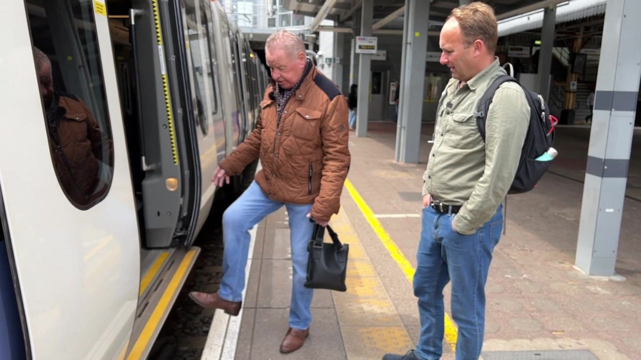 Mr Kern hovers his foot over the gap between the Tube train and the platform, showing the size of the gap