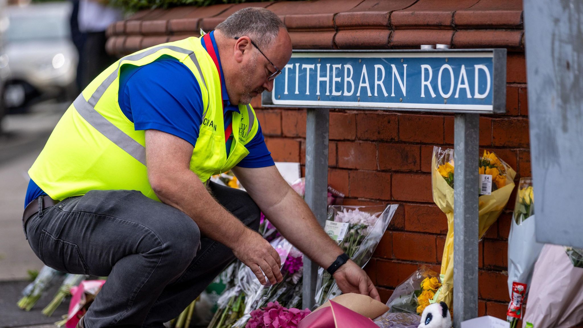 A person leaves flowers near the scene in Hart Street, Southport, where three children died and eight were injured in a "ferocious" knife attack during a Taylor Swift event at a dance school on Monday. 