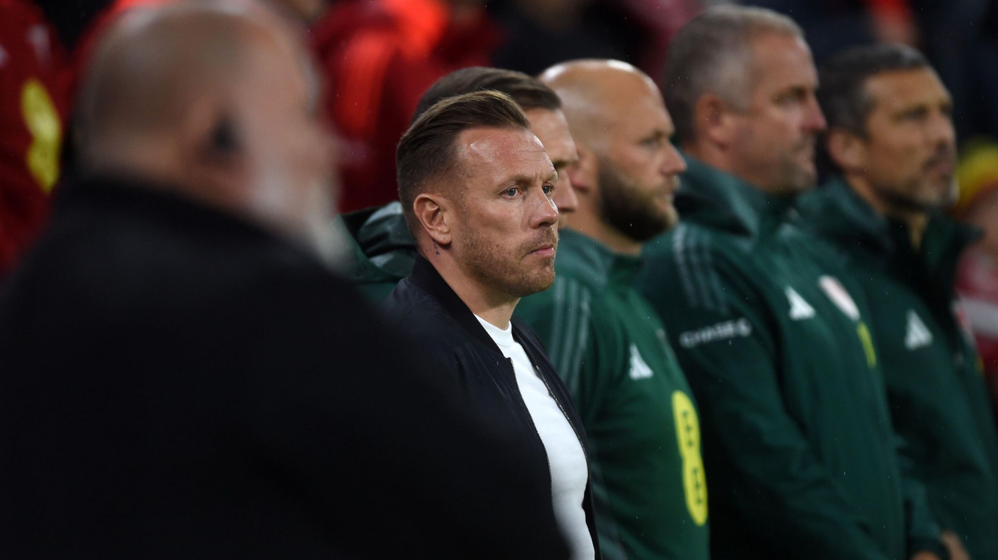 Craig Bellamy stands alongside coaching staff at Cardiff City Stadium