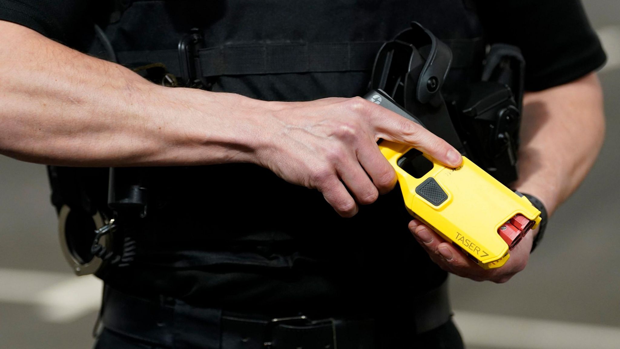 A police officer holding a Taser