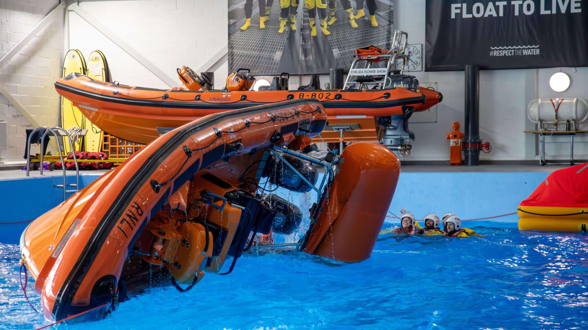 A demonstration of a lifeboat capsize in the sea survival pool at the RNLI College during the festival weekend