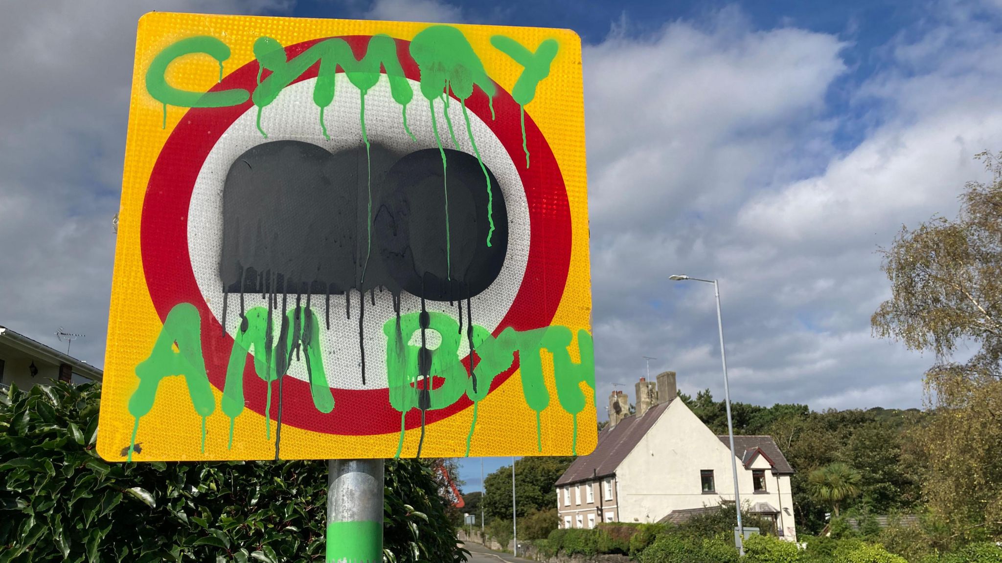 A 20mph sign which has been defaced with graffiti 
