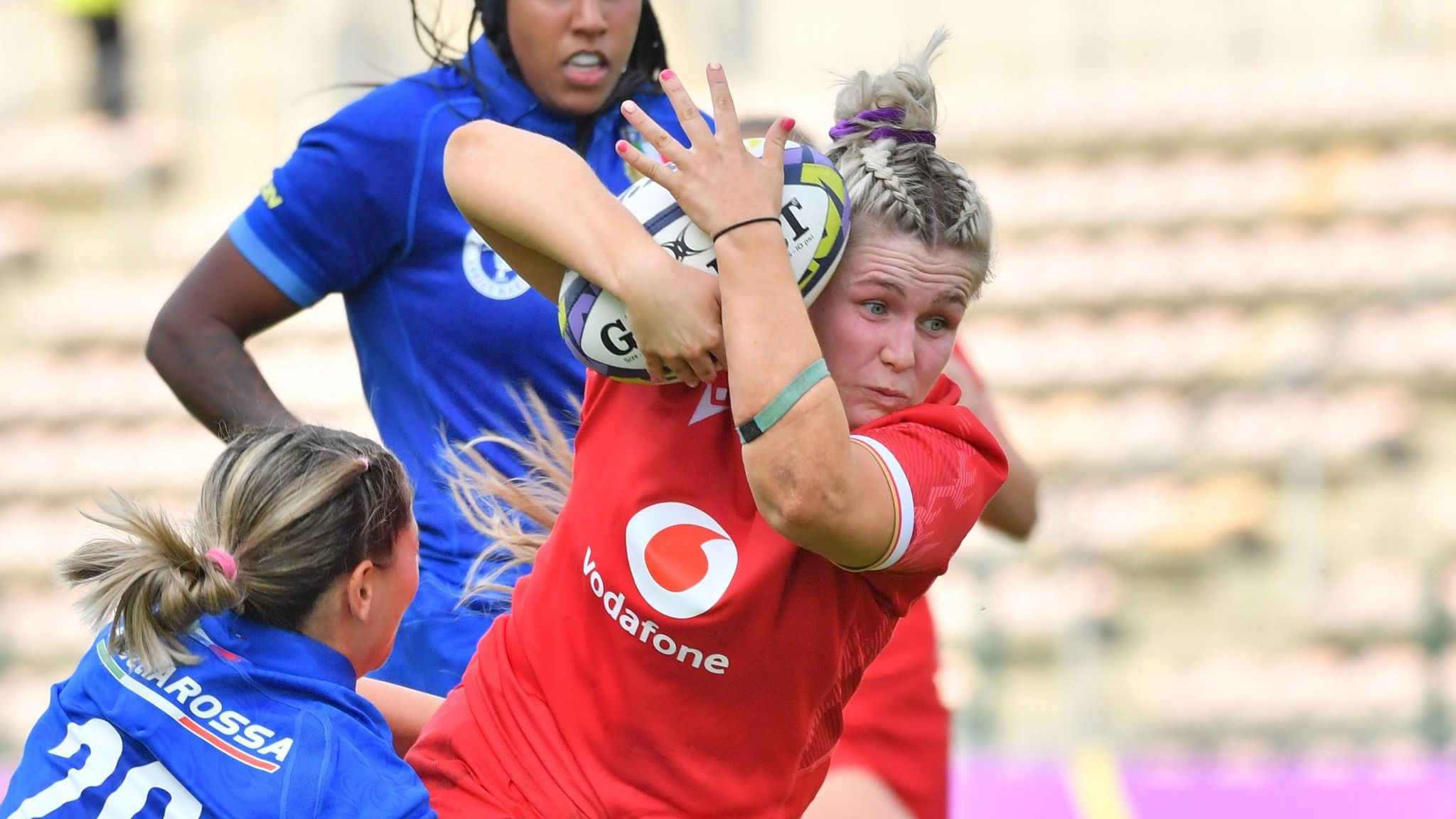 Alex Callender is tackled by the Italian players