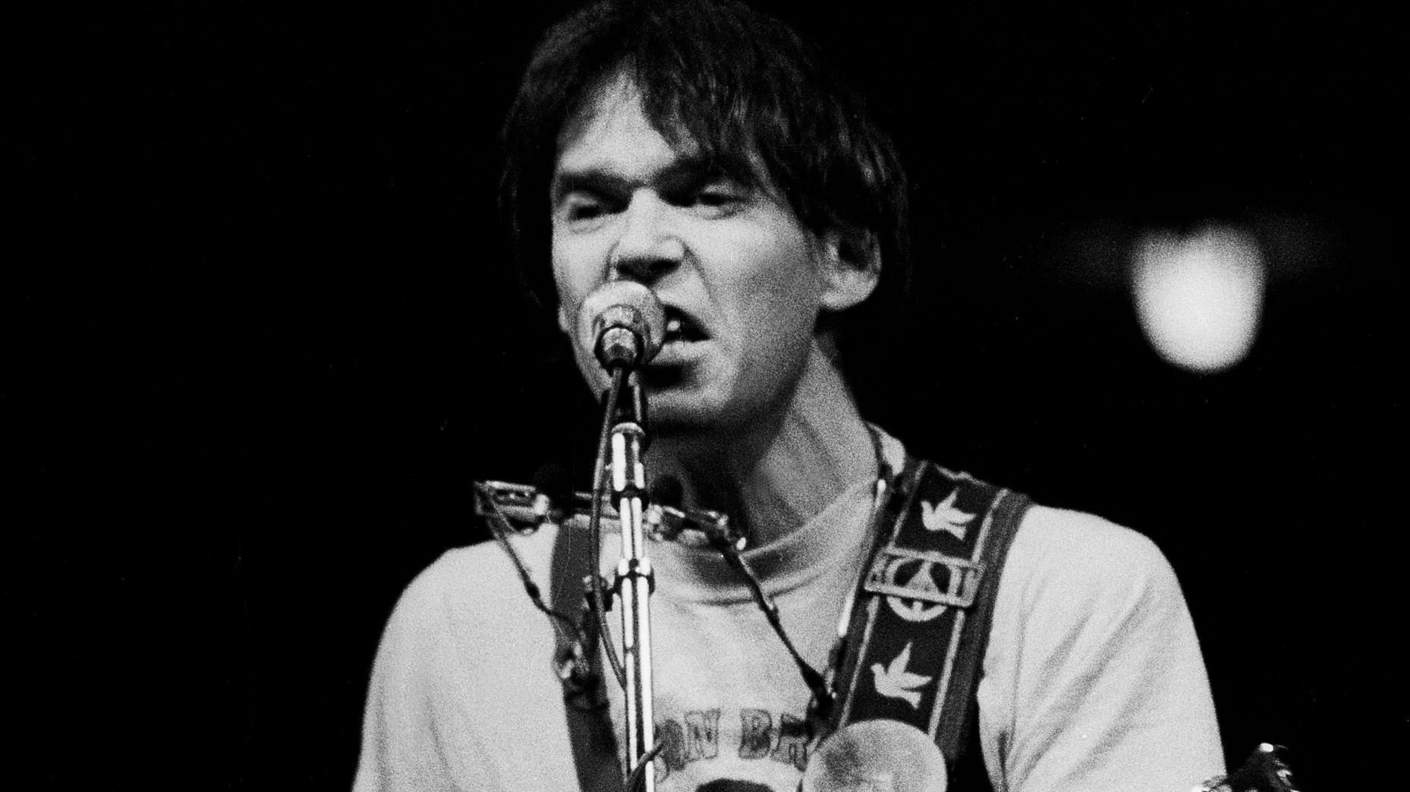 Canadian Folk and Rock musician Neil Young plays guitar as he performs onstage at the Chicago Stadium, Chicago, Illinois, October 14, 1978. 