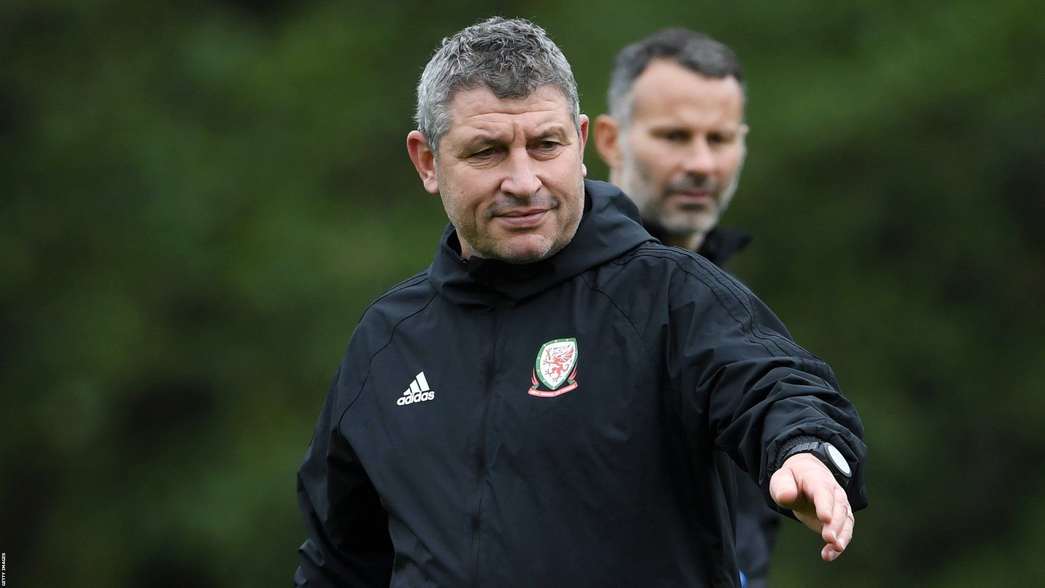 Osian Roberts with Wales manager Ryan Giggs in the background