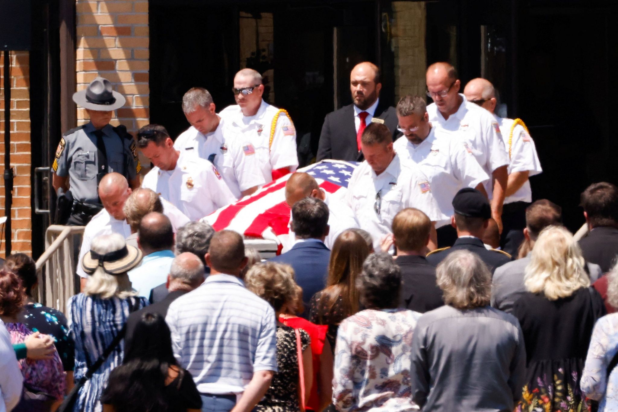 Firefighters carry the coffin of Corey Comperatore, who was killed in the attack