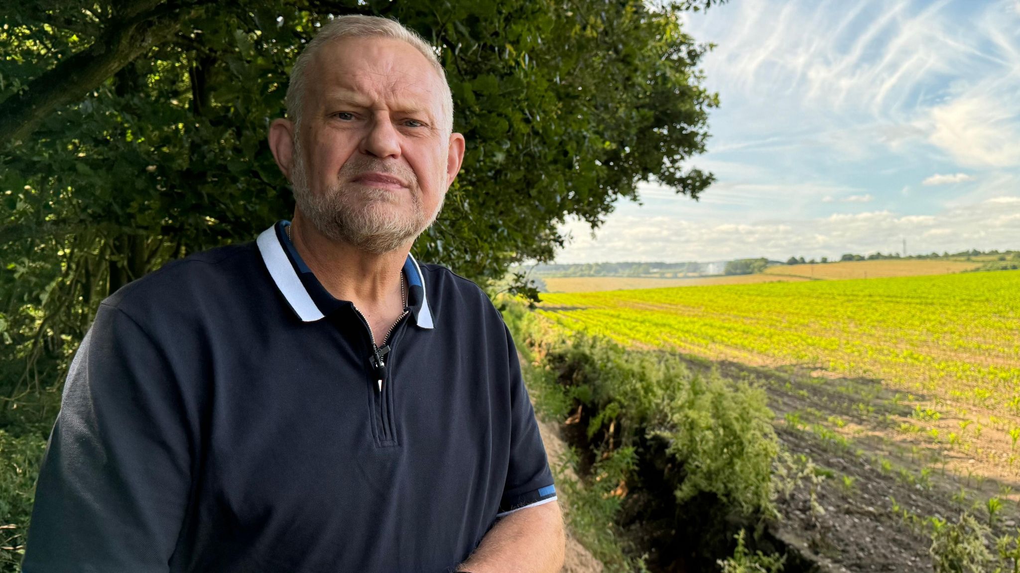 Russell Lowbridge standing by the ditch on farmland where his grandad's remains were found