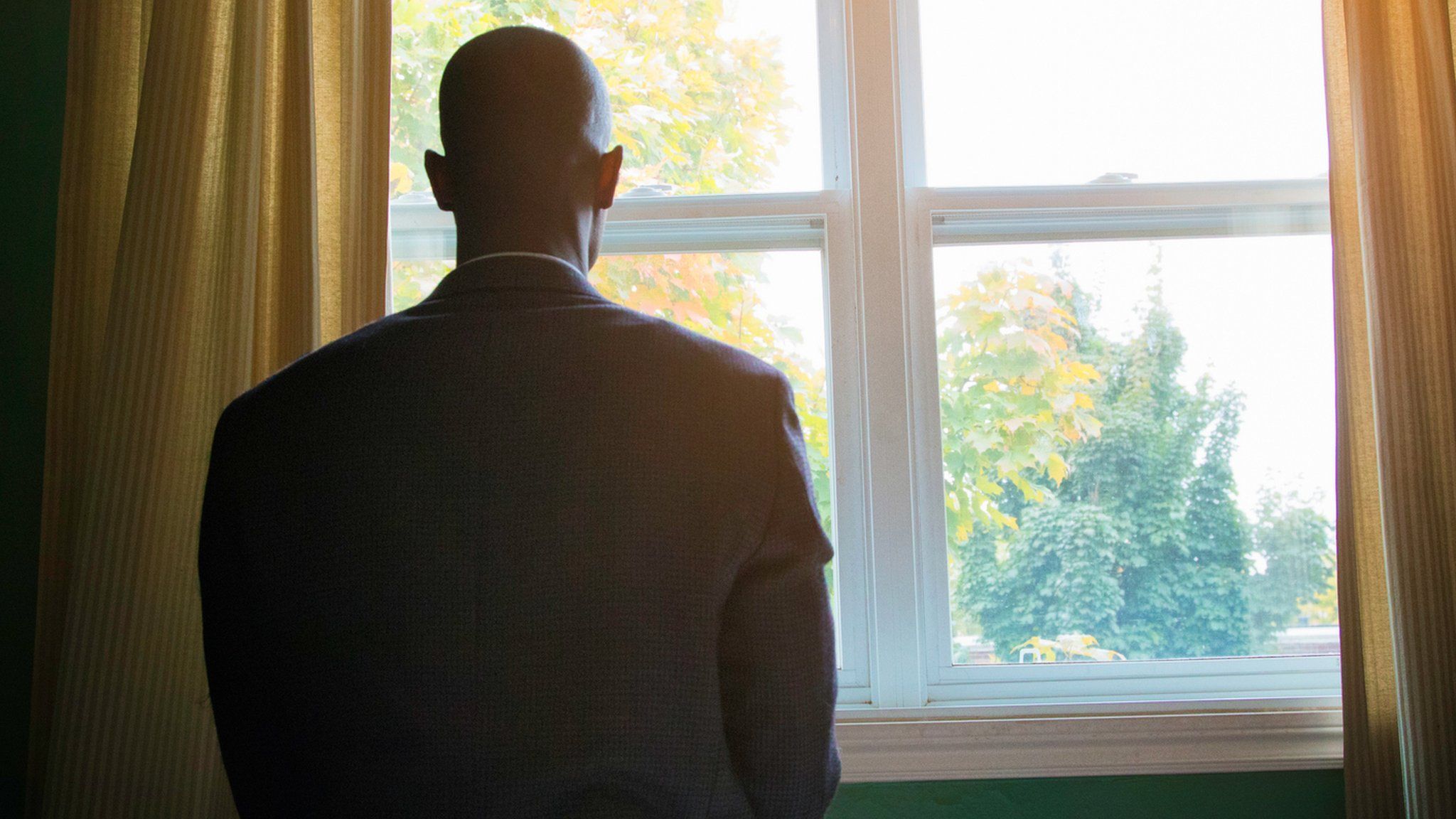 Man staring out of window