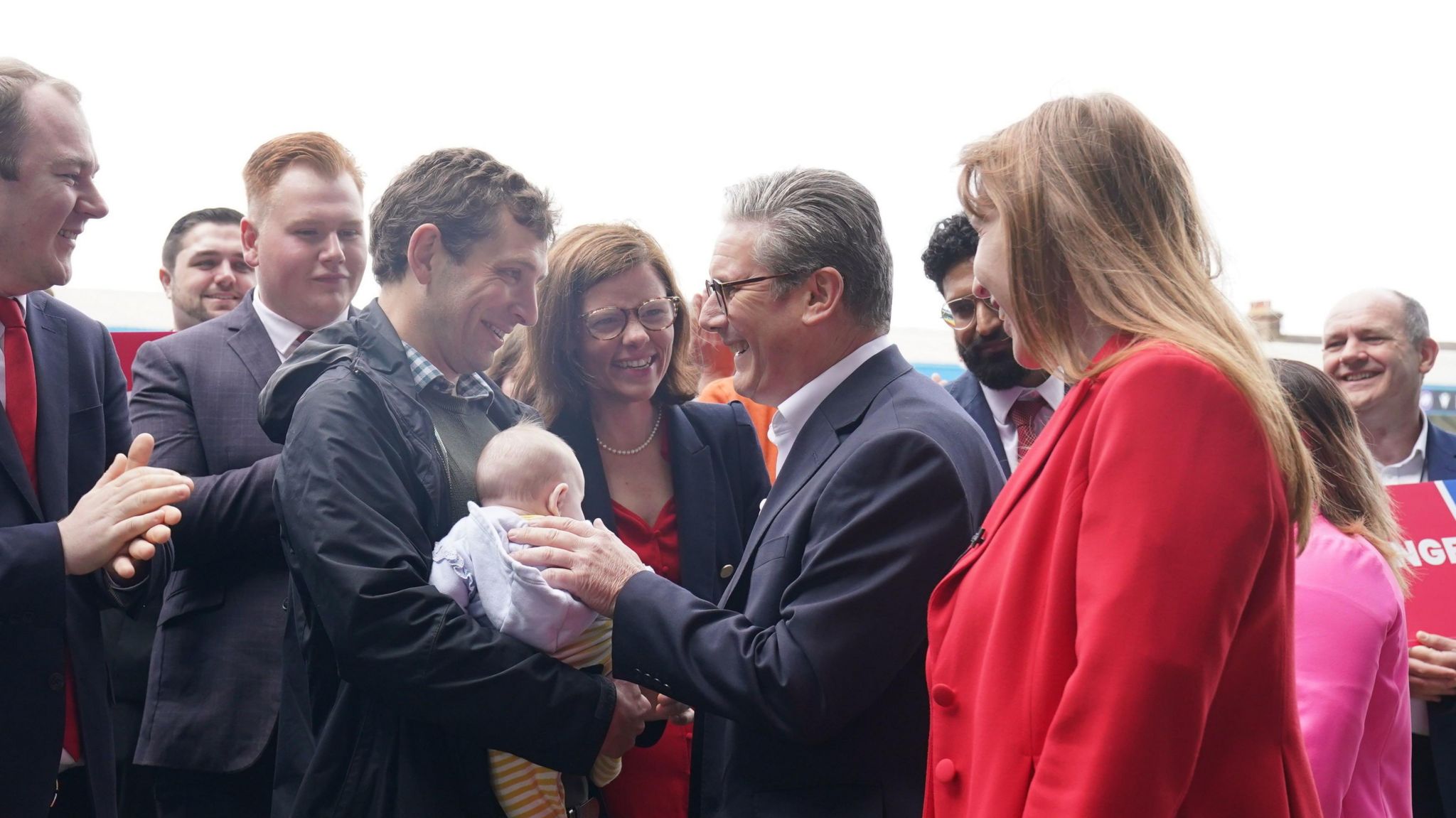 Sir Keir Starmer greets a man with a baby in Gillingham, Kent