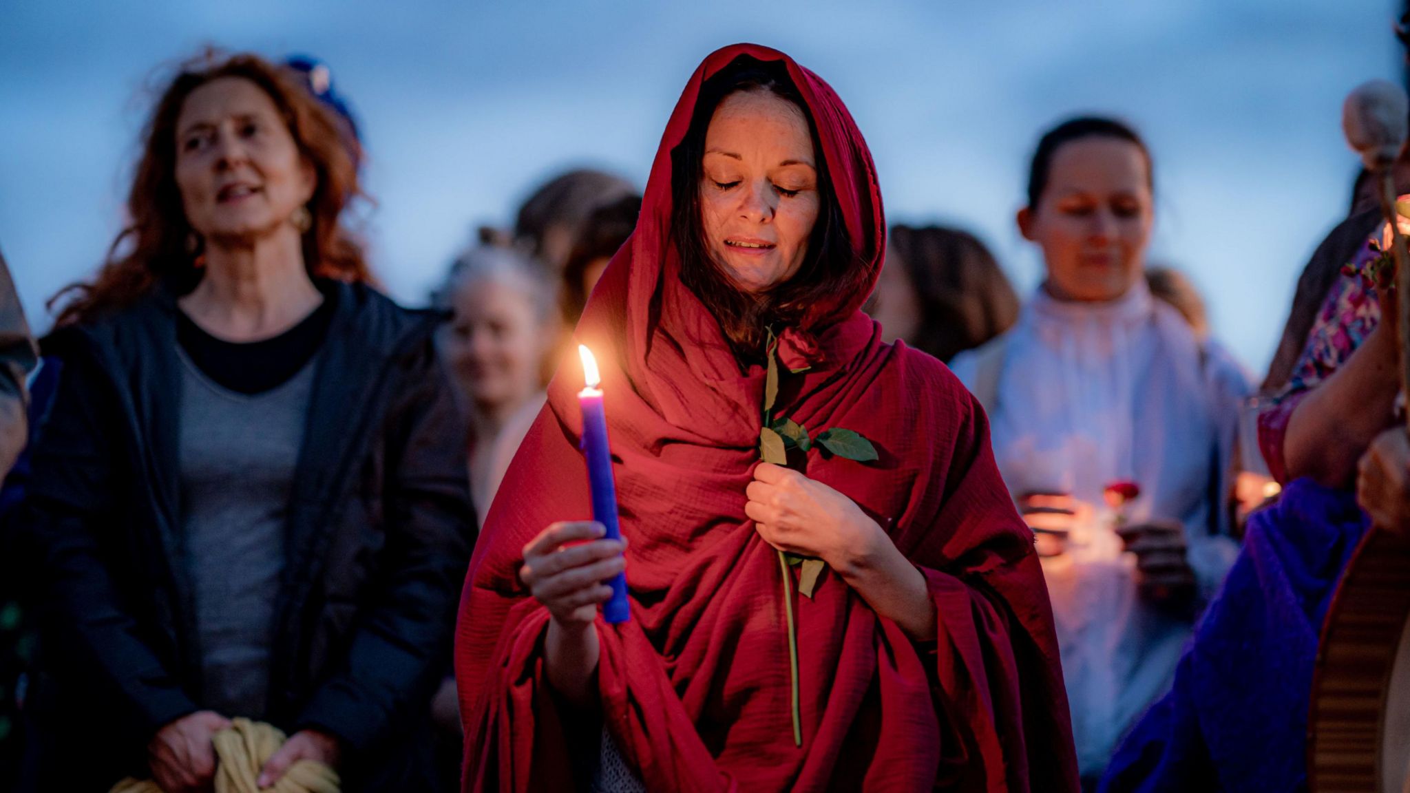 Magdalene Rose Priestess, Caroline Glazebrook carries a candle