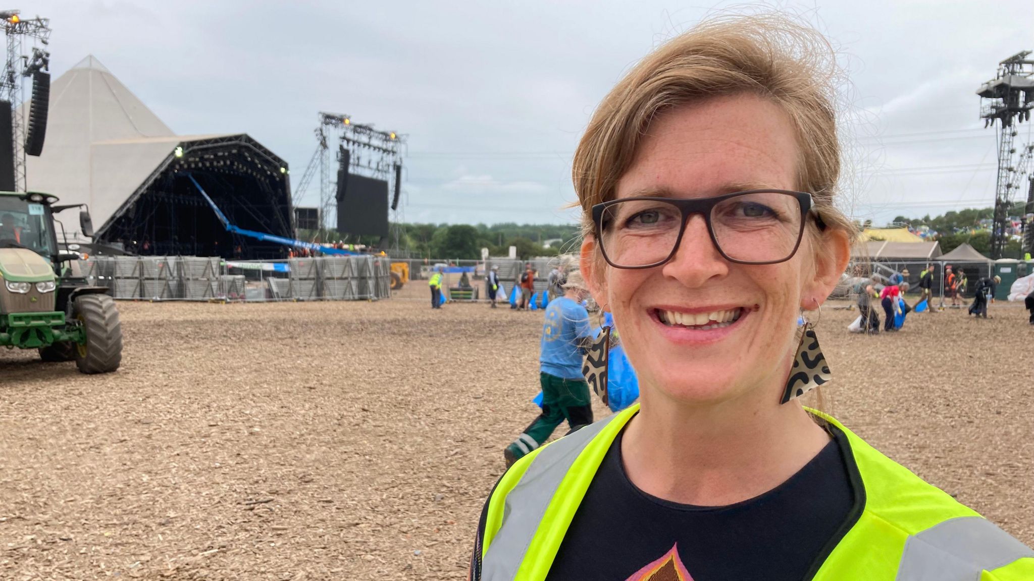 Woman in high-viz stood in front of the Pyramid Stage