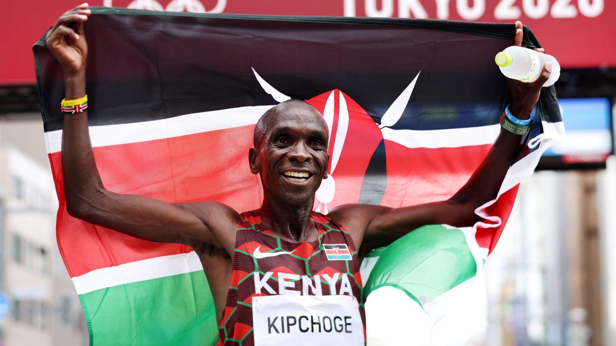 Eliud Kipchoge poses with a Kenyan flag as he celebrates winning the marathon at the Tokyo 2020 Olympic Games
