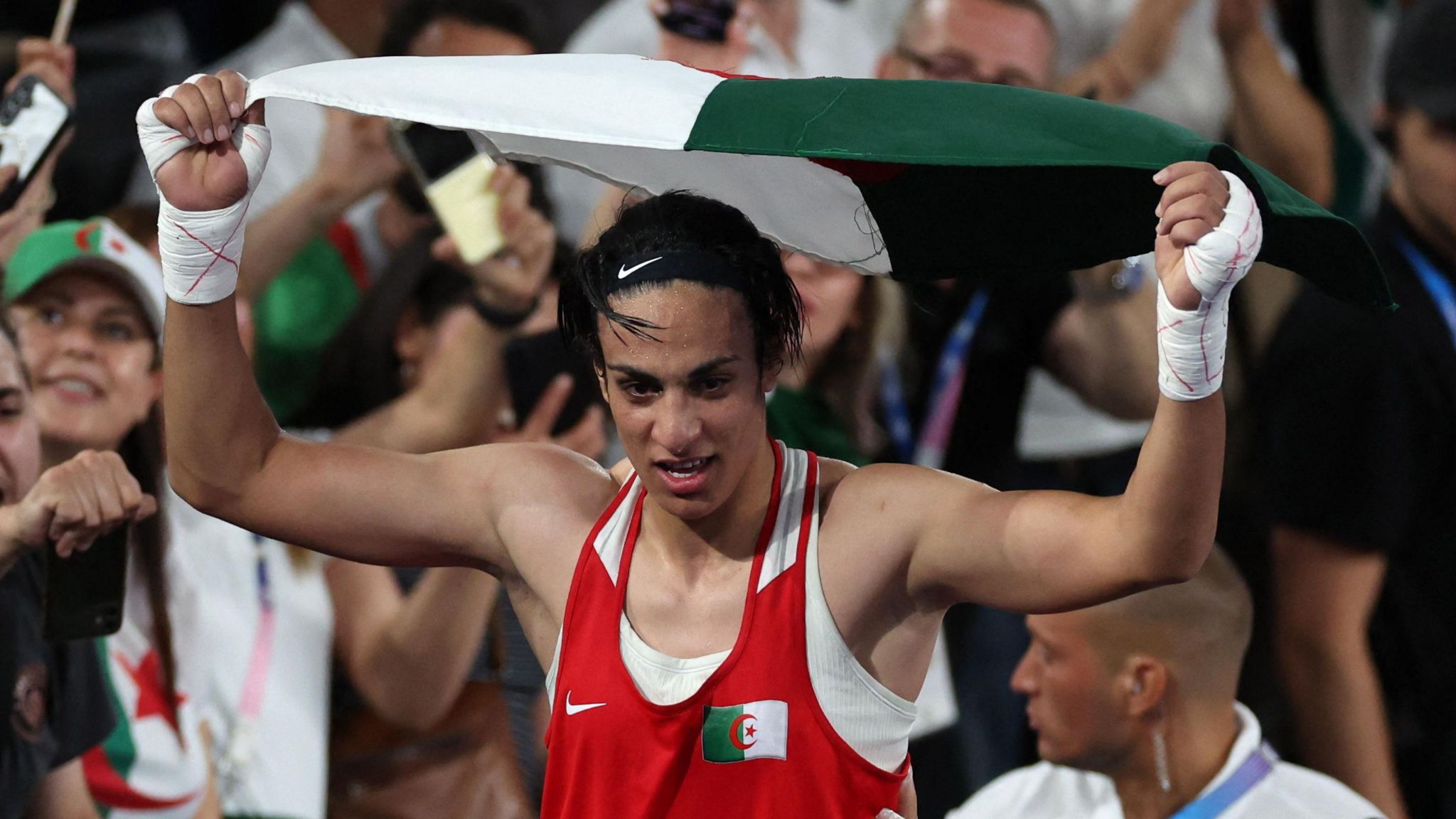 Khelif holds aloft an Algerian flag