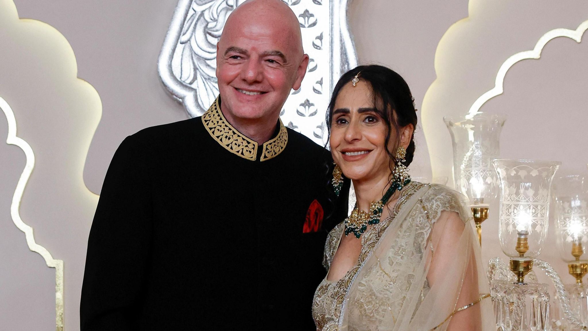 Gianni Infantino and his wife Leena Al Ashqar pose for pictures on the red carpet