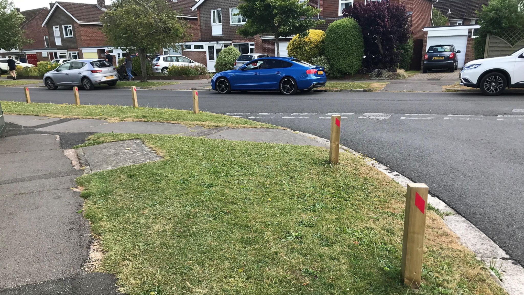 Parking wooden posts in use close to The Manor Park School to stop parking on vergess