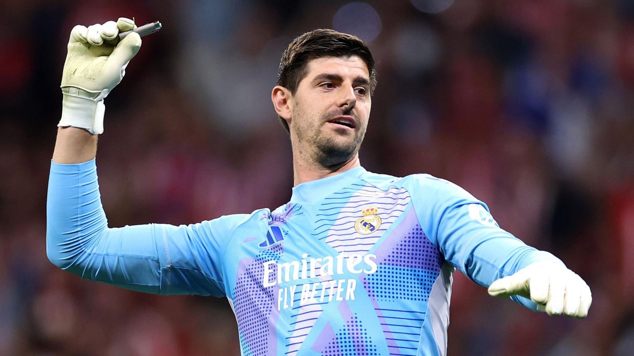 Real Madrid goalkeeper Thibaut Courtois with a lighter in his right glove