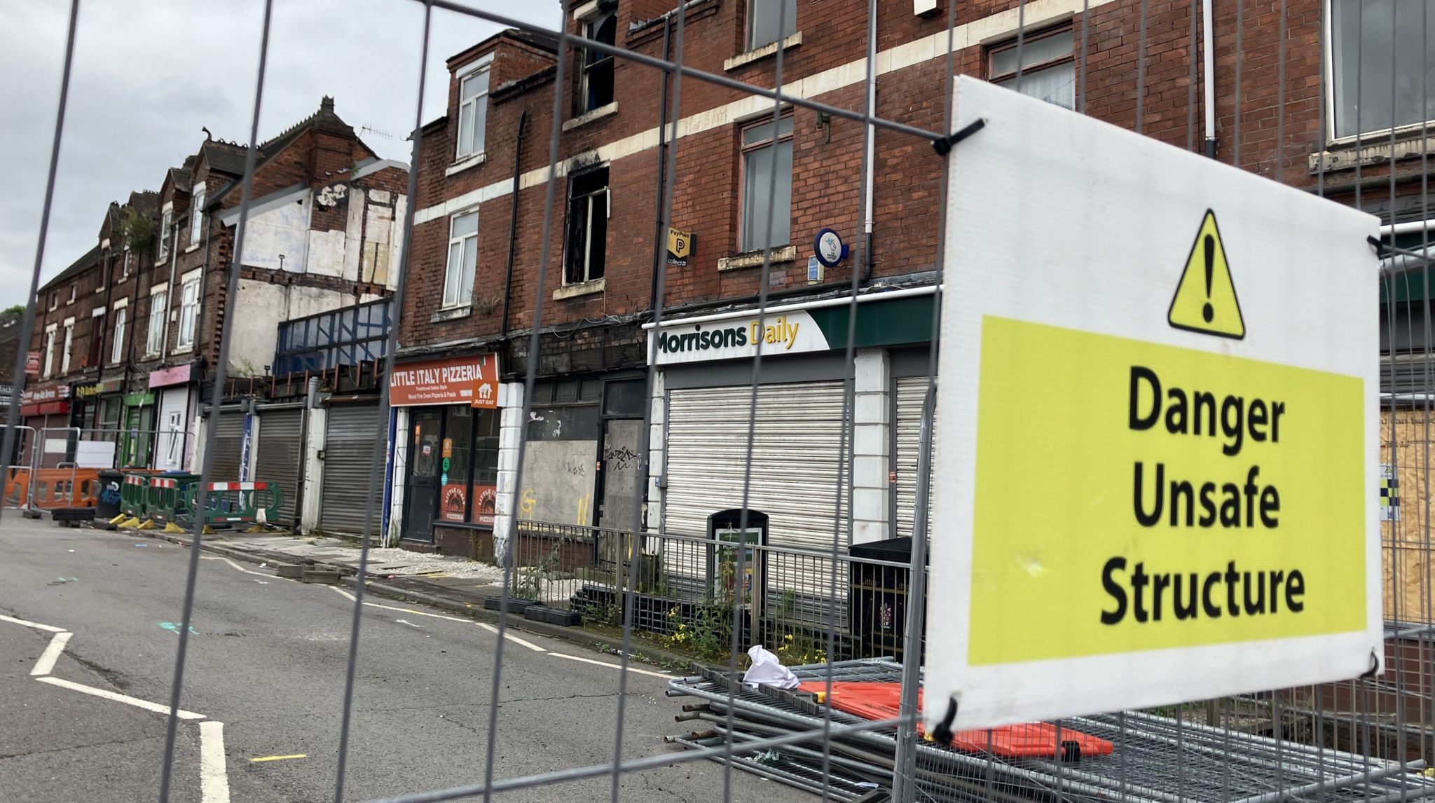 Fencing with sign which read 'Danger Unsafe Structure'