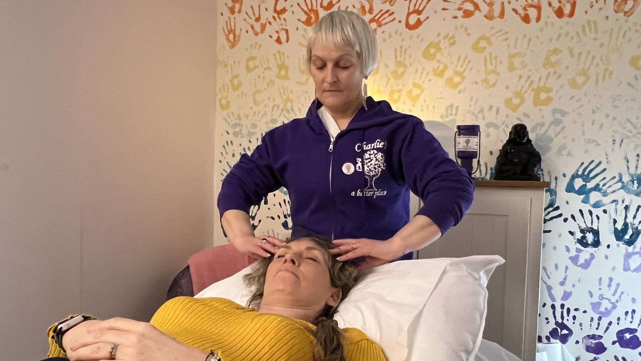 Faye Czajkowski-Davis receiving a head massage from Jo Sutherland