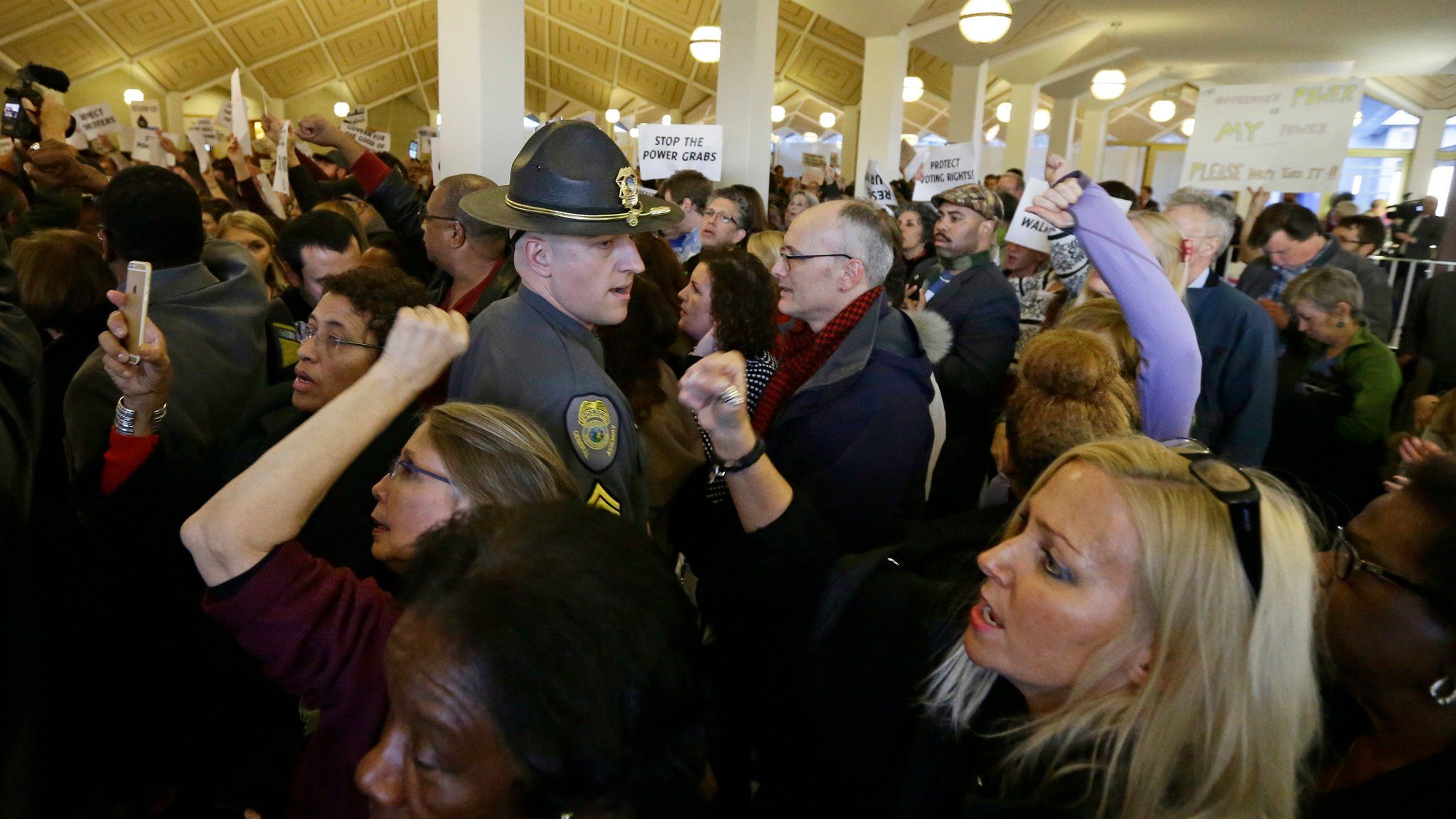 Demonstrators crowd the rotunda outside the House and Senate galleries during a special session at the North Carolina Legislature in Raleigh, N.C., Thursday, Dec. 15, 2016.