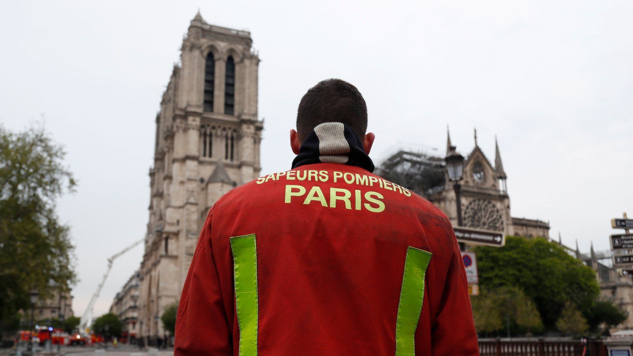 A firefighter stands outside Notre-Dame Cathedral in Paris on April 16, 2019, in the aftermath of a fire that caused its spire to crash to the ground