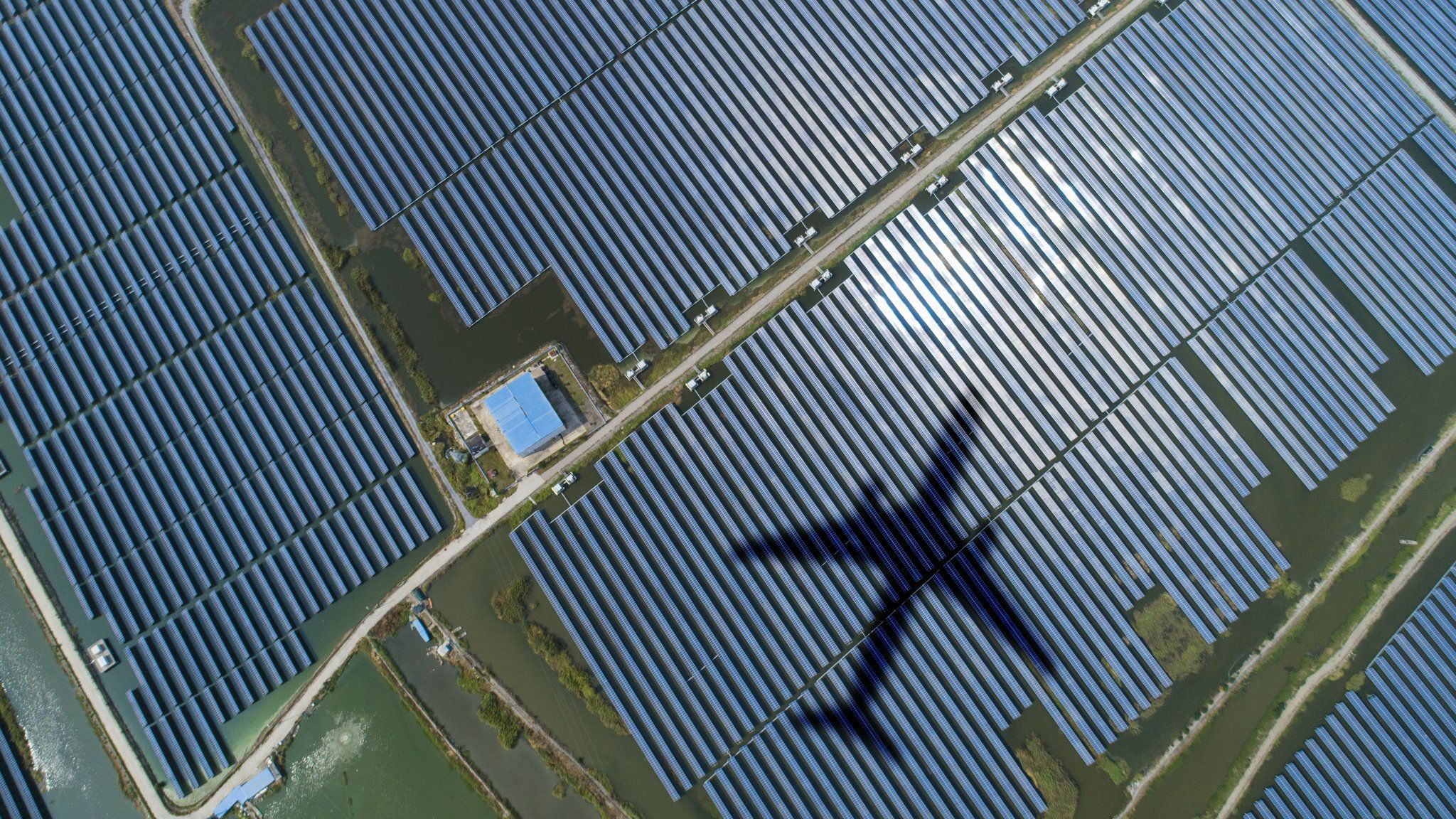 Solar energy panels with shadow of a plane