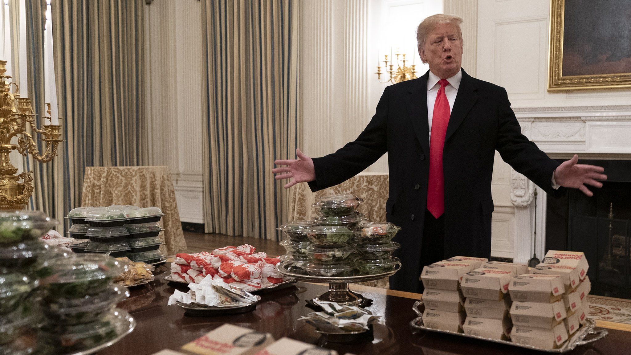 US President Donald Trump presents fast food to be served to the Clemson Tigers football team