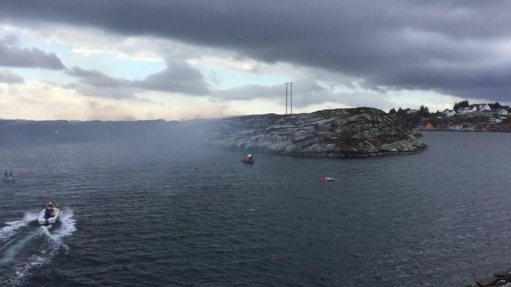 Boats and smoke near the site of helicopter crash off Bergen