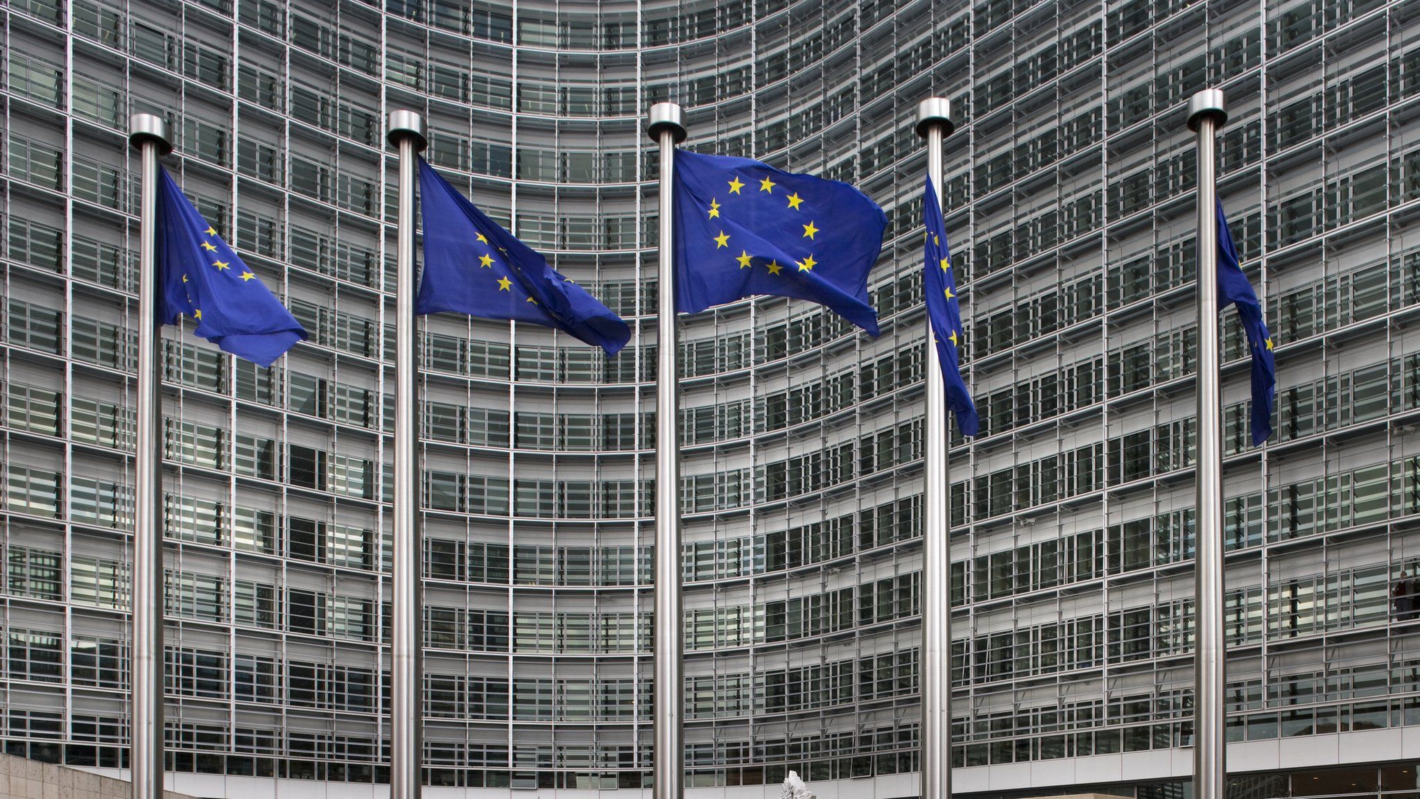 European Union flags next to the European Commission headquarters in Brussels