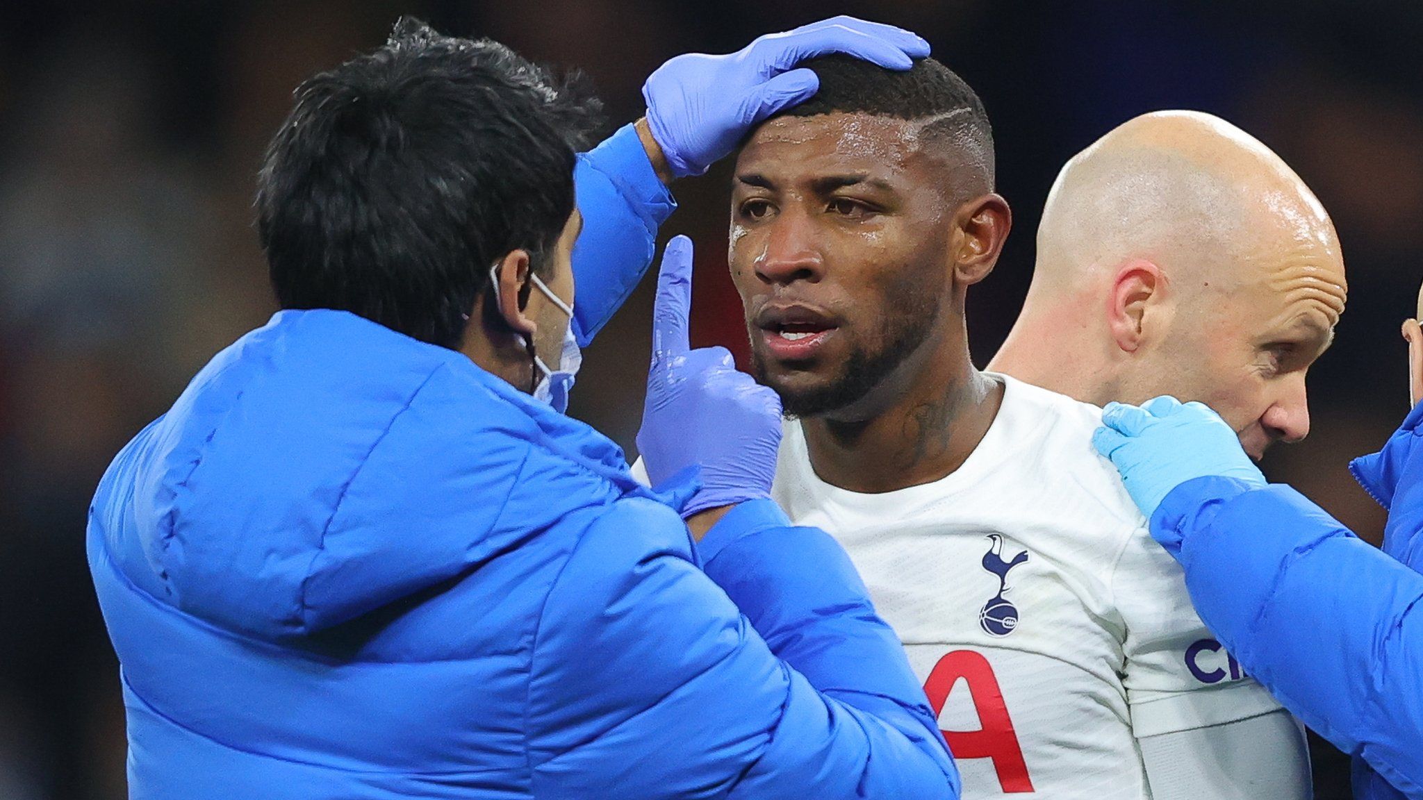 Emerson Royal of Tottenham Hotspur is checked for signs of concussion during the Premier League match between Manchester City and Tottenham Hotspur at Etihad Stadium