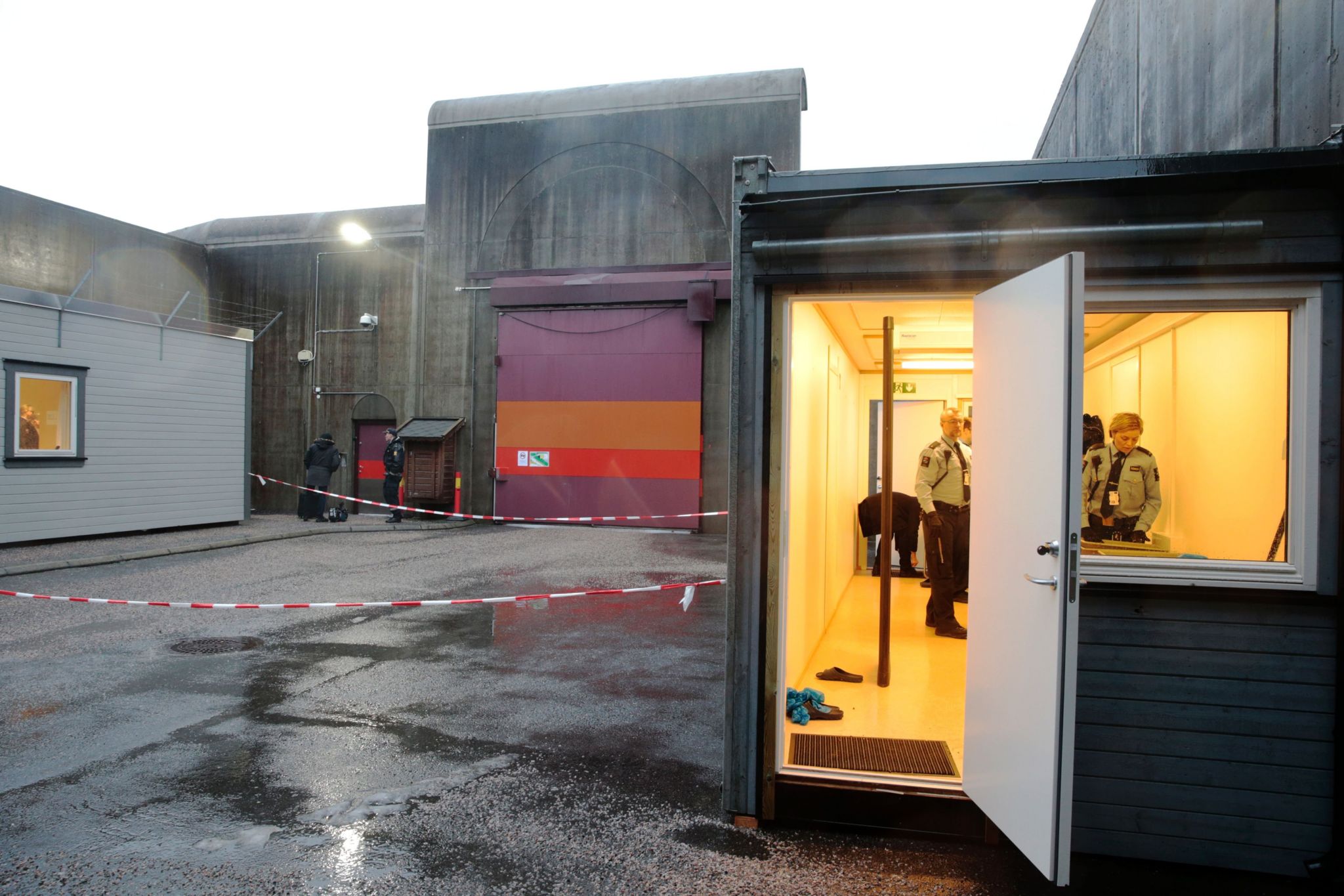 Police officers stand in the entrance of the Telemark prison in Skien, Norway