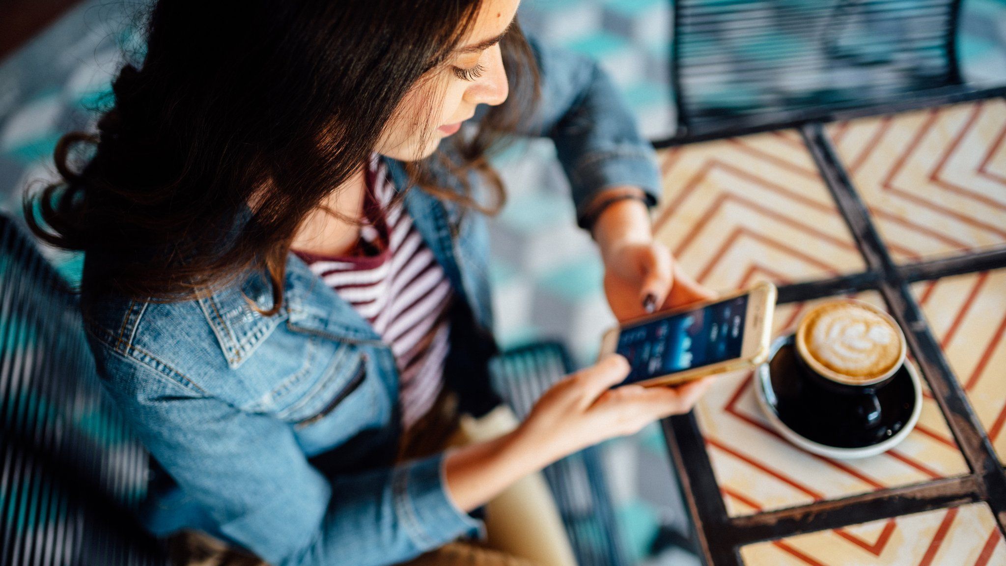 Young woman using trading app on phone