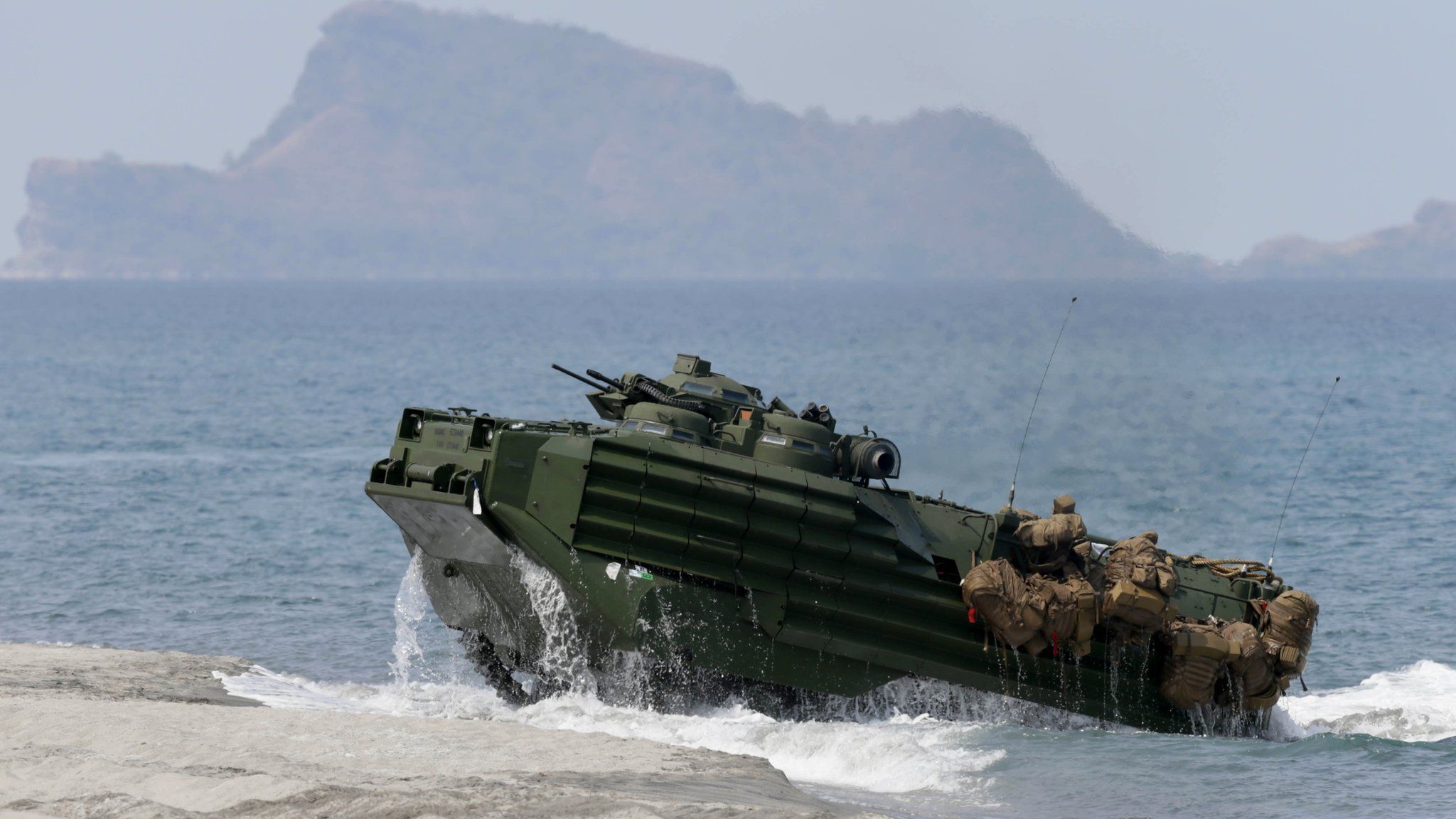 File photo: A US amphibious assault vehicle with Philippine and US troops on board storms the beach at a combined assault exercise at a beach facing one of the contested islands in the South China Sea known as the Scarborough Shoal in the West Philippine Sea, 21 April 2015