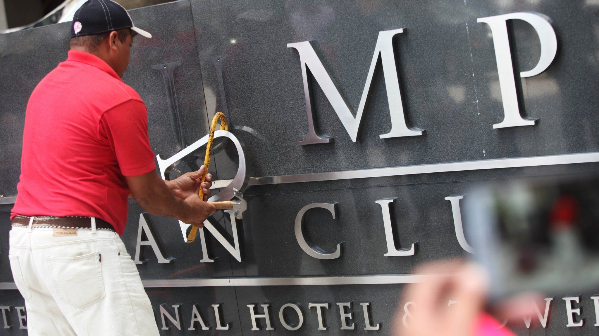 A worker changes the Trump Ocean Club Hotel's sign in Panama City, Panama, 5 March 2018