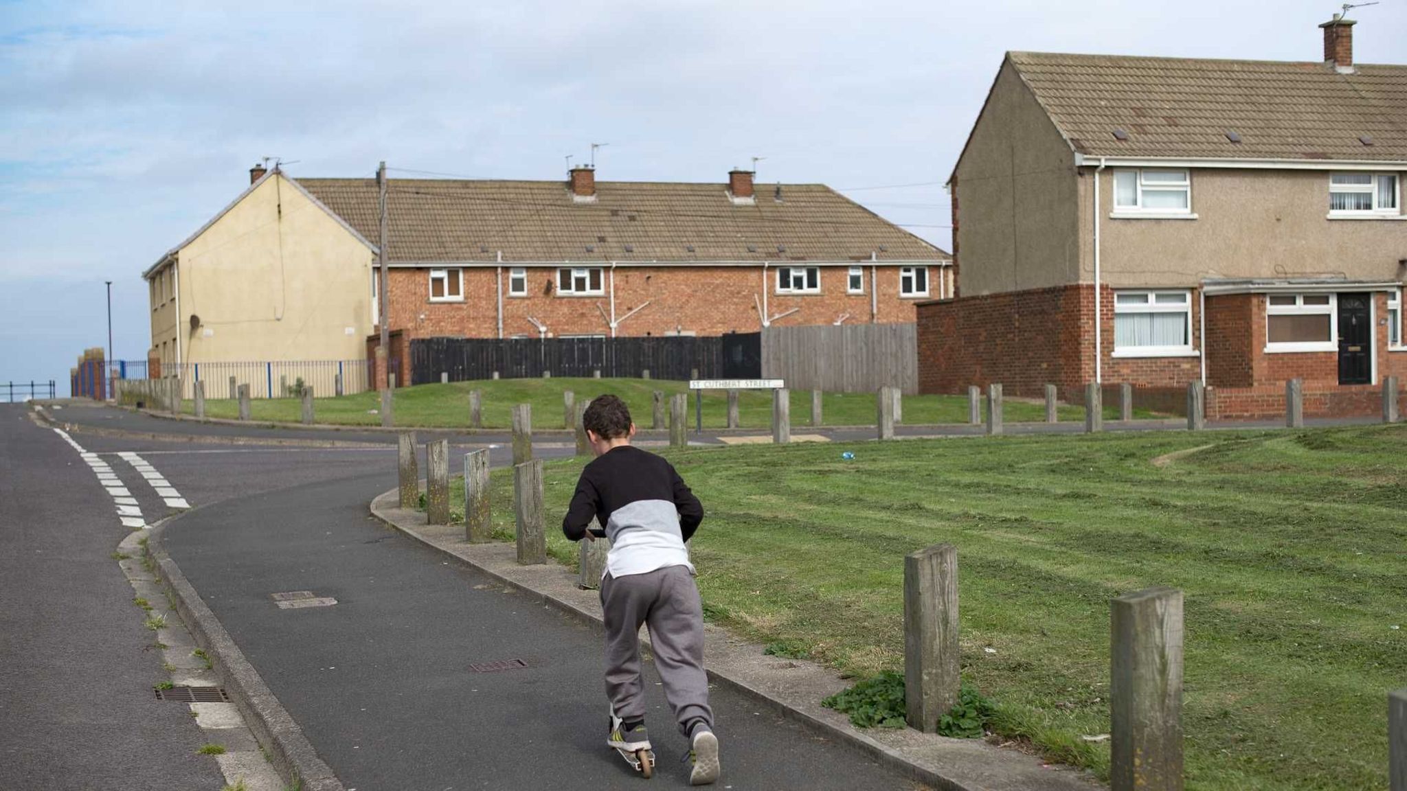 Child riding a scooter on a housing estate in Hartlepool