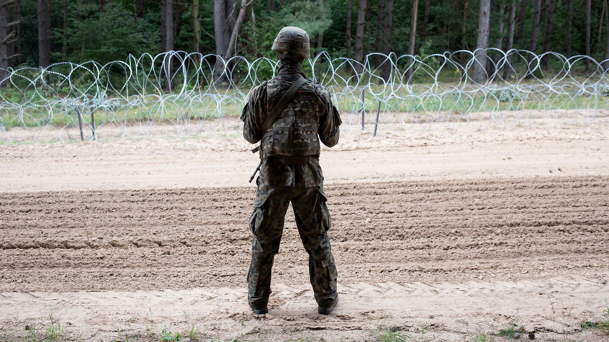 Polish army soldier in front of border between Poland and Belarus. On August 26, 2021 at Border Poland-Belarus