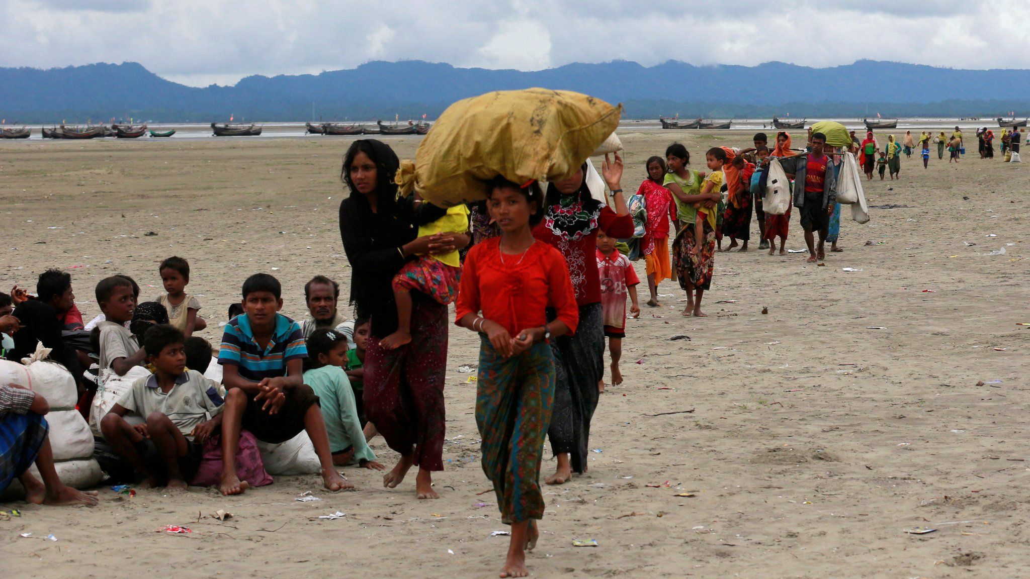 Rohingya refugees walk to a Border Guard Bangladesh (BGB) post after crossing the Bangladesh-Myanmar border by boat through the Bay of Bengal in Shah Porir Dwip, Bangladesh, 10 September 2017
