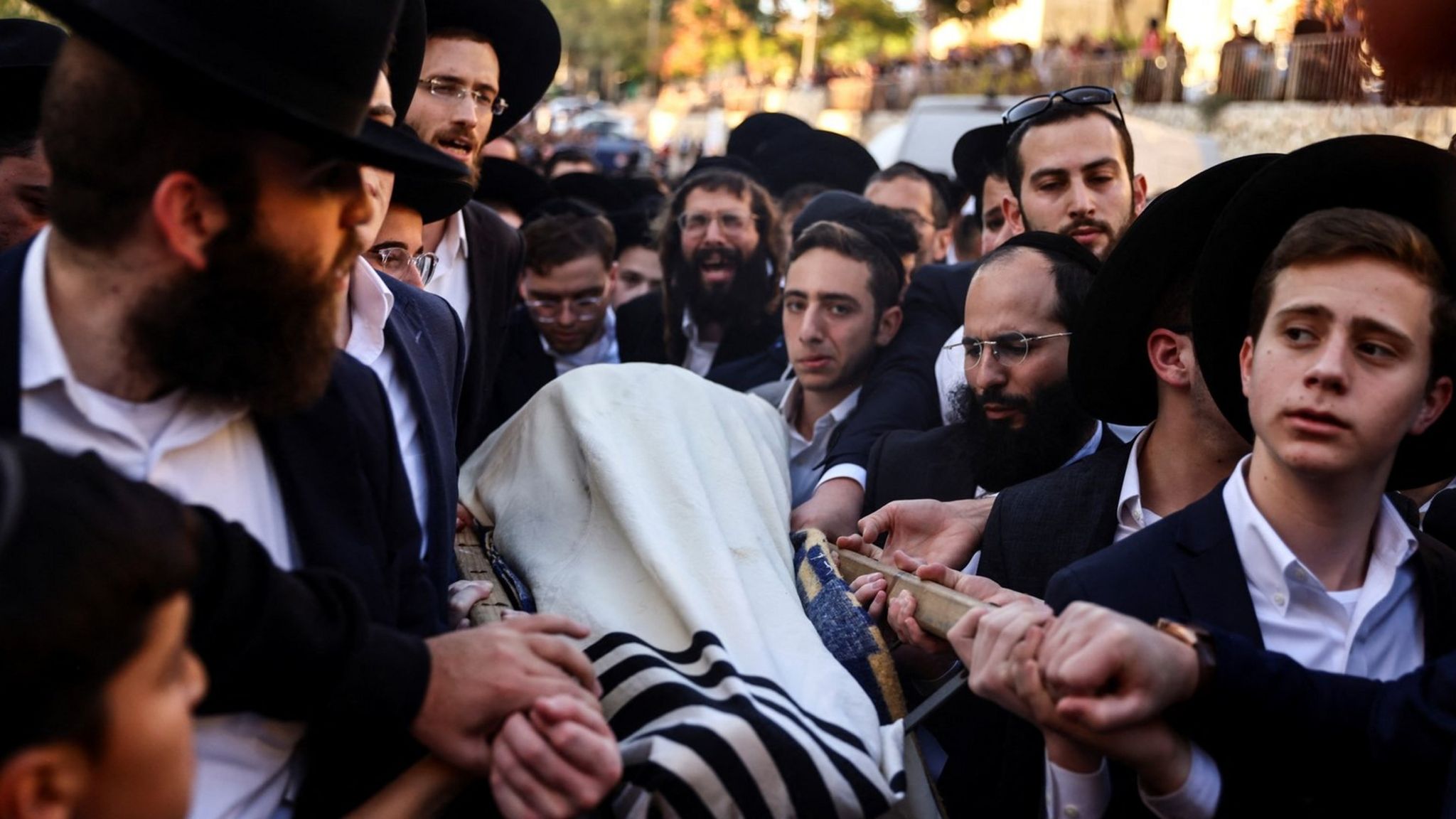 Mourners carry the body of Aryeh Schupak, 15, at his funeral in Jerusalem (23 November 2022)