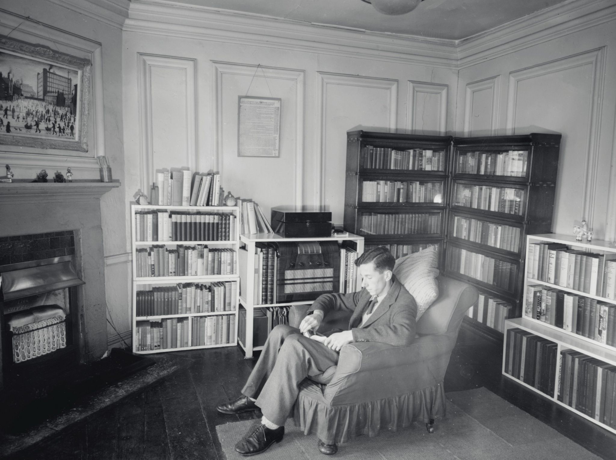 The Lowry seen (top left) hanging in Leonard Hamilton's accommodation at the University of Oxford