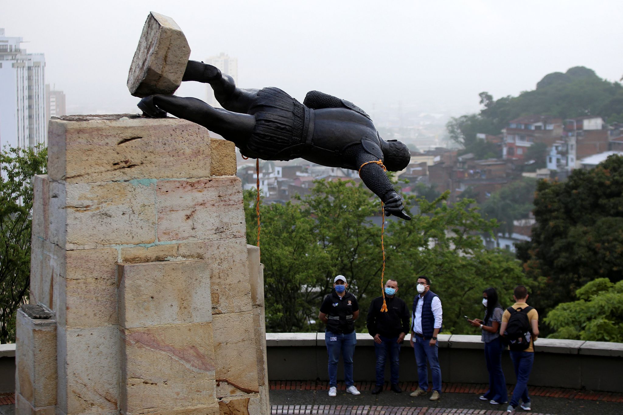 The statue of Sebastian de Belalcazar, a 16th century Spanish conqueror, lies after it was pulled down by indigenous people in Cali, Colombia, on April 28, 2021. -