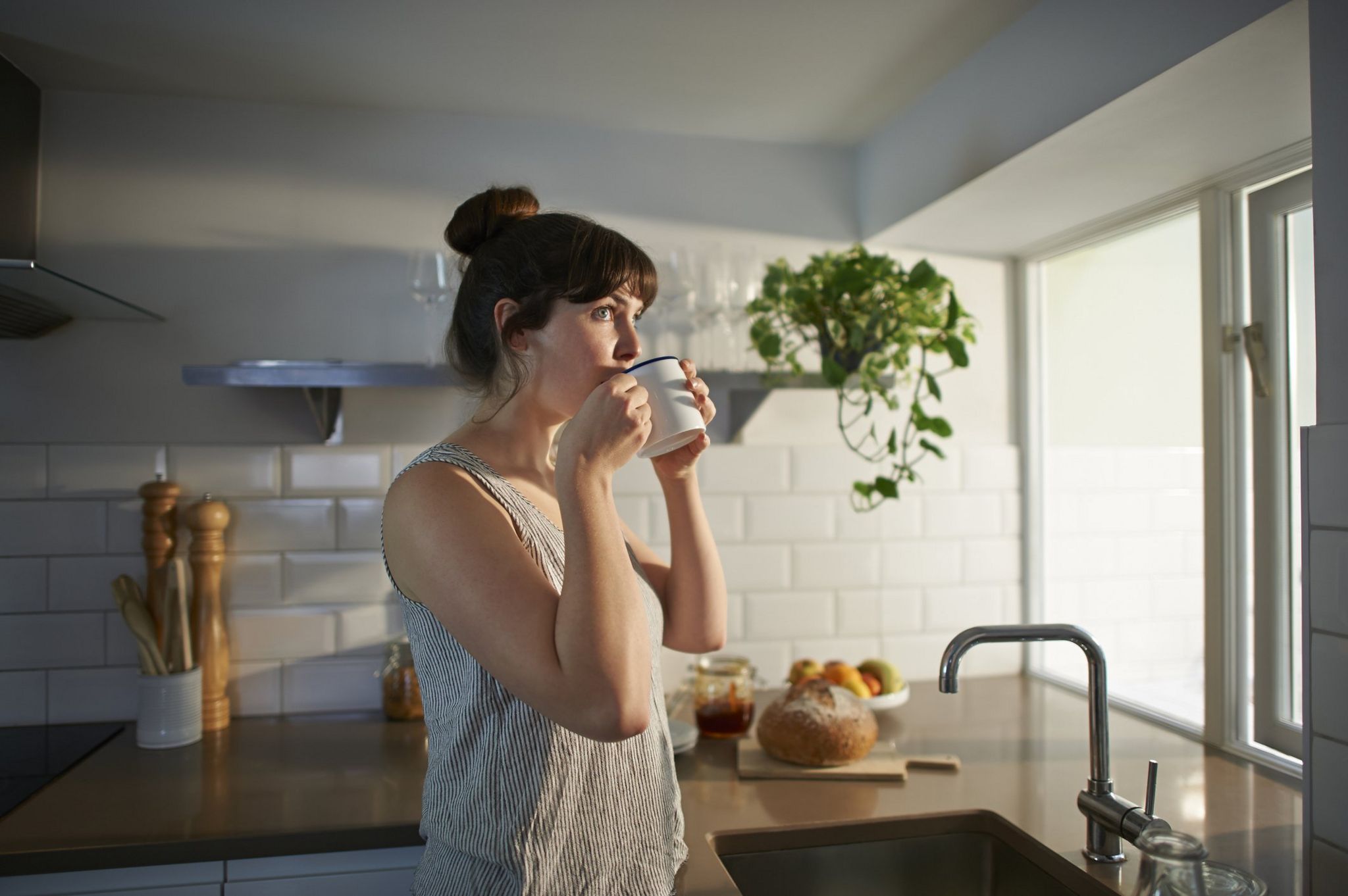 Photo of a woman drinking tea at home