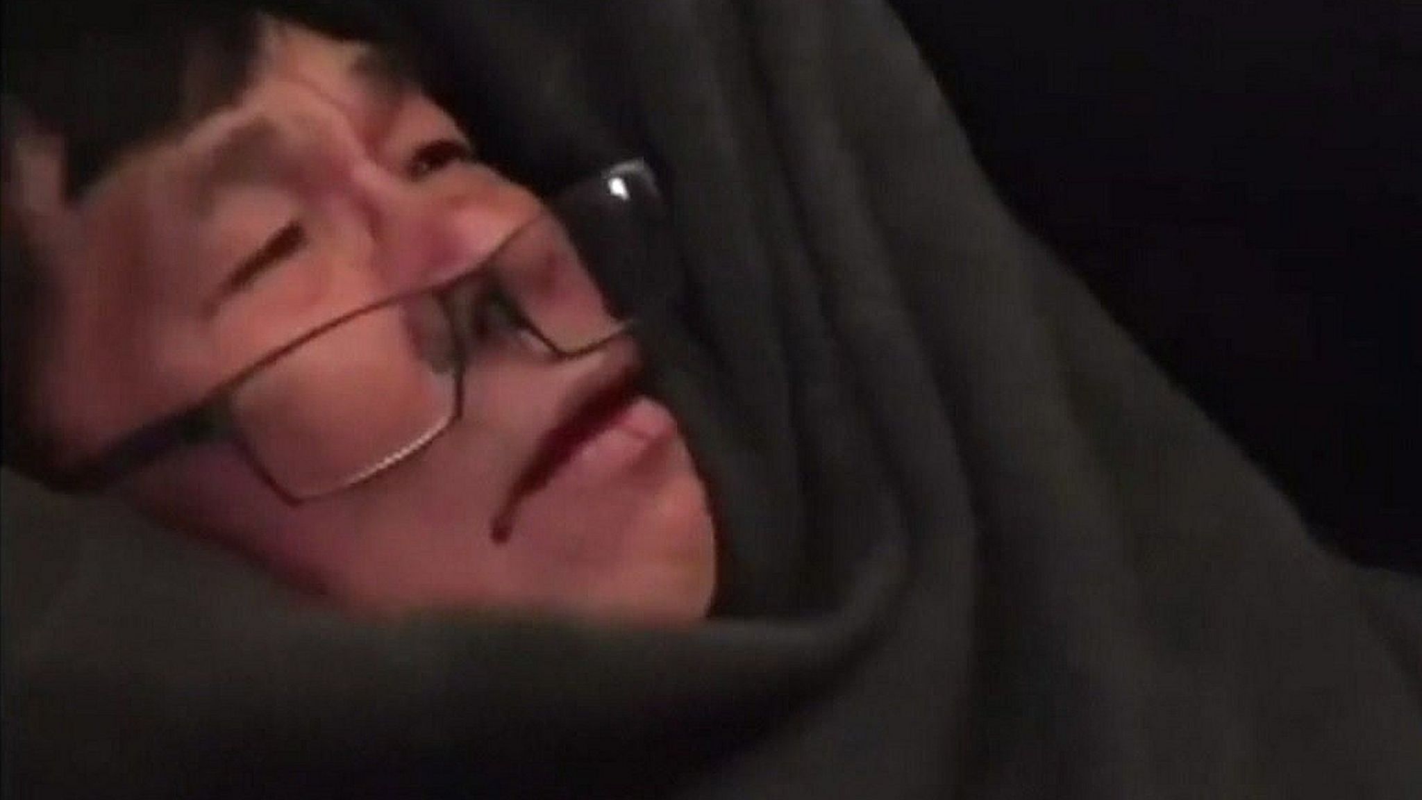 Passenger seen with glasses falling off and blood on his mouth